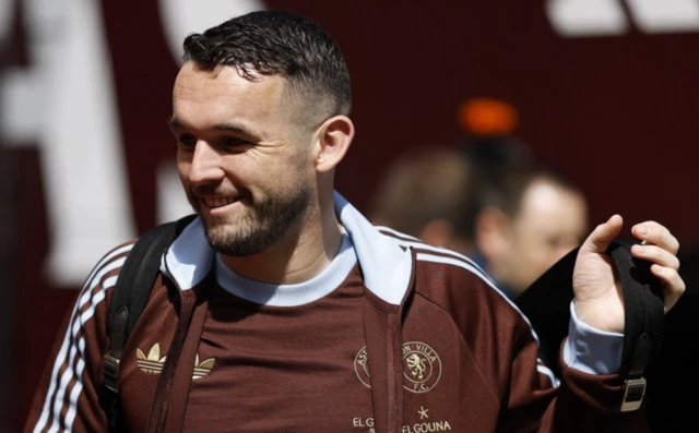 John McGinn wearing a brown Aston Villa branded jacket