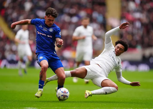 Rochdale's Luke Hannant (left) and Boreham Wood's Leon Ayinde battle for the ball