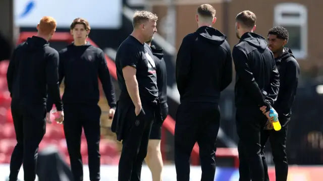 Salford players gather on the pitch before the game