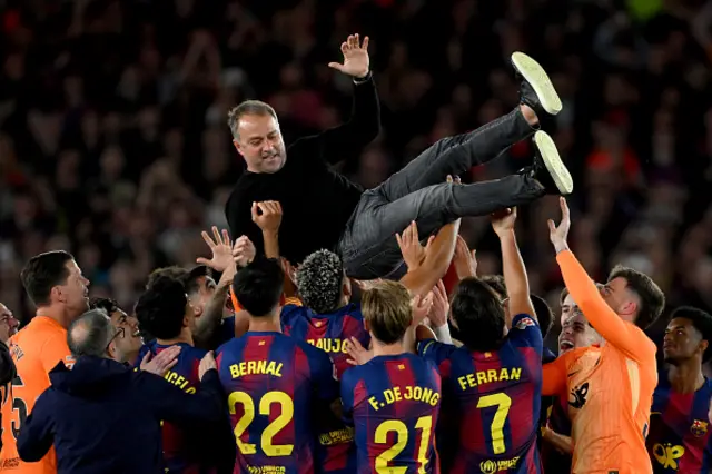 Hansi Flick, Head Coach of FC Barcelona, is thrown in the air by players of FC Barcelona