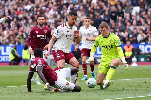 Hermansen blocks with his legs as Saliba tries to poke home