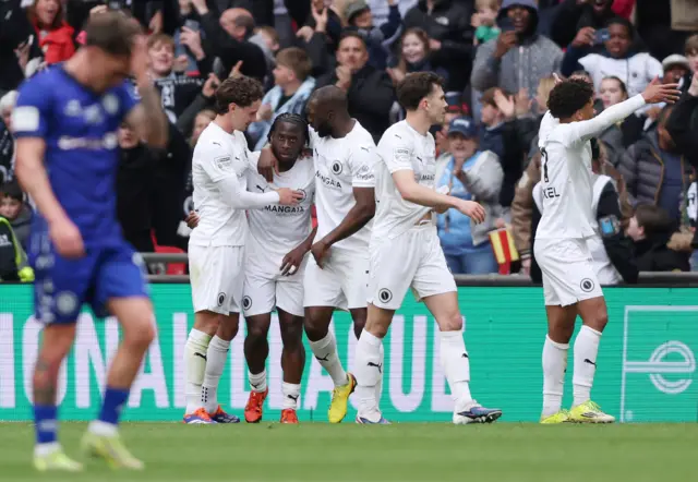 Abdul Abdulmalik of Boreham Wood celebrates scoring his team's second goal with teammates