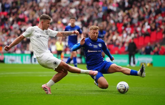 Boreham Wood's Zak Brunt (left) and Rochdale's Harvey Gilmour battle for the ball