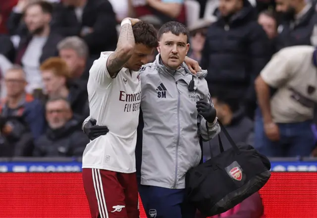 Arsenal's Ben White walks off the pitch after being substituted after sustaining an injury.