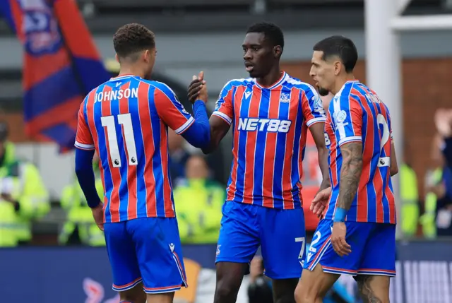 Crystal Palace's Ismaila Sarr celebrates scoring their first goal with Brennan Johnson and Daniel Munoz.