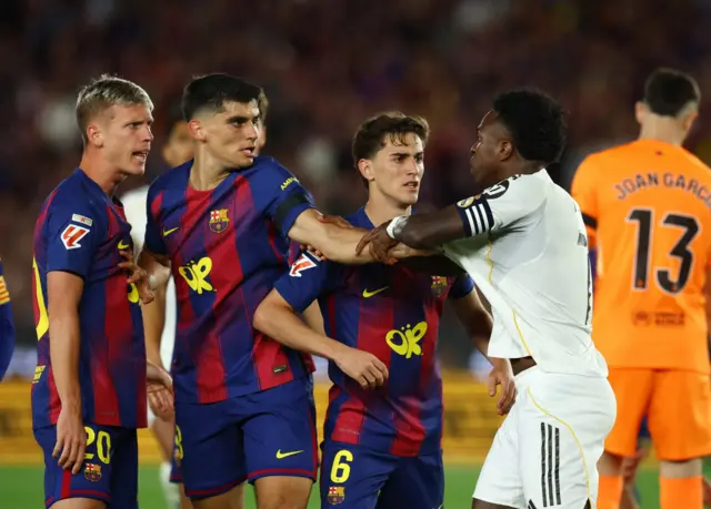 Real Madrid's Vinicius Junior clashes with FC Barcelona's Dani Olmo, Gavi and Gerard Martin