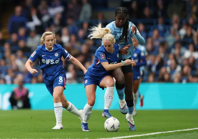 Khadija Shaw is challenged by Ellie Carpenter