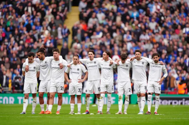 Boreham Wood players look on during a penalty shootout