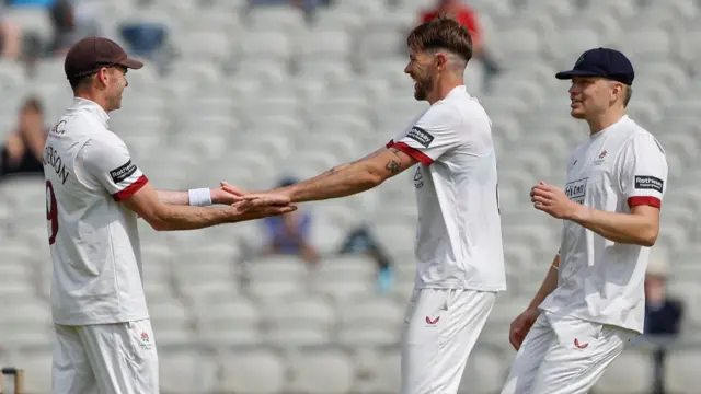Lancashire's Tom Bailey (C) celebrates a wicket with captain James Anderson