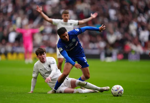 Boreham Wood's Lewis Richardson (left) and Rochdale's Tyler Smith battle for the ball