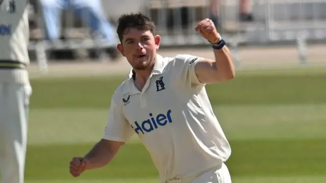 Warwickshire's Ethan Bamber punches the air after taking a wicket