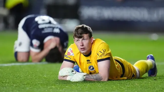 Millwall goalkeeper Anthony Patterson lies on the ground following Hull's second goal