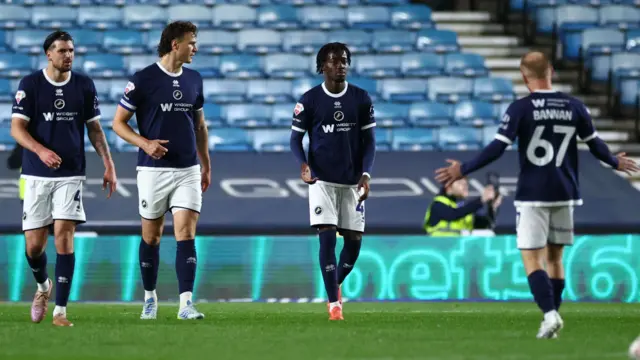 Millwall players look disconsolate after conceding