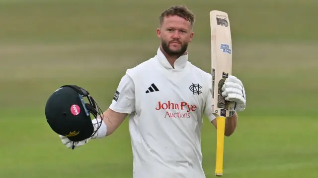 Nottinghamshire's Ben Duckett raises his bat after reaching a century