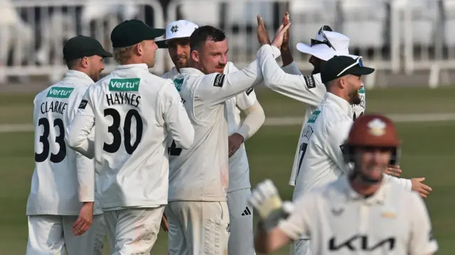 Nottinghamshire's Liam Patterson-White (C) celebrates a wicket against Surrey