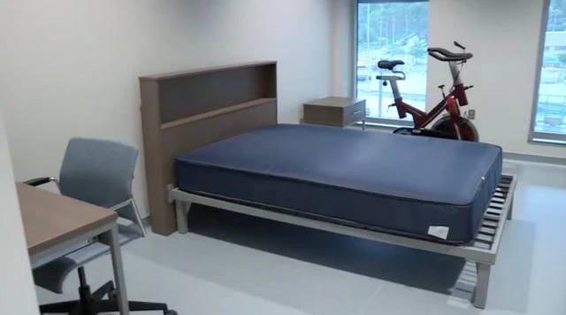 A bed at the University of Nebraska Medical Center, and a desk and workout bike