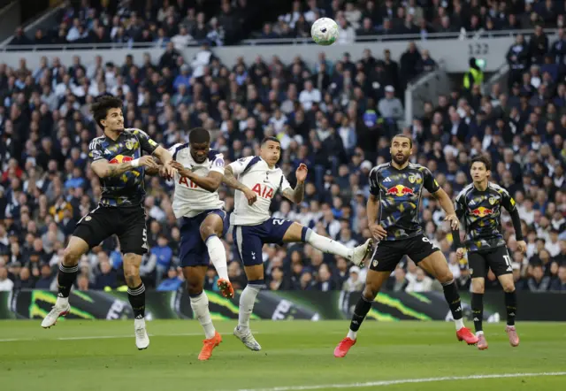 Players from both teams contest a cross