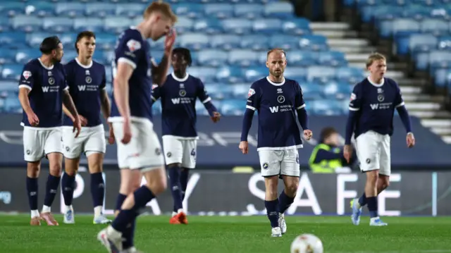 Millwall players look dejected after conceding