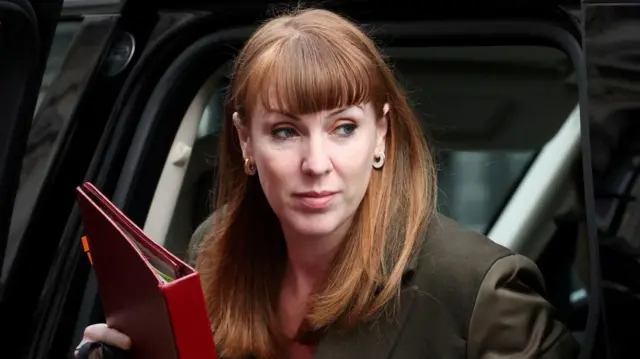 Angela Rayner steps out of a car holding a red folder