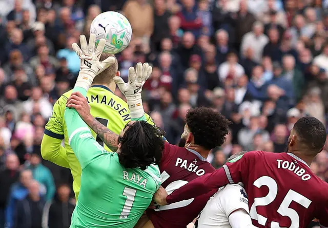 West Ham players Pablo and Todibo foul Arsenal goalkeeper David Raya