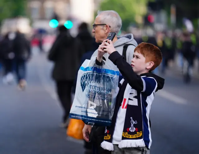 Young spurs fan takes a picture of the stadium