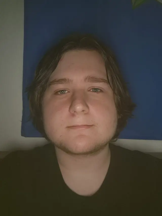 Joe from Leeds looks directly at the camera wearing a black t-shirt