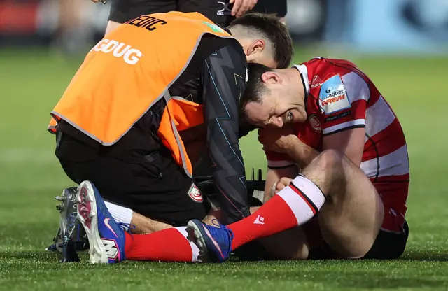 Tomos Williams is treated for an injury with Gloucester