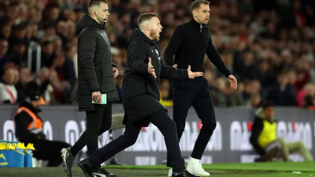 Kim Hellberg theatrically reacts to a decision on the touchline