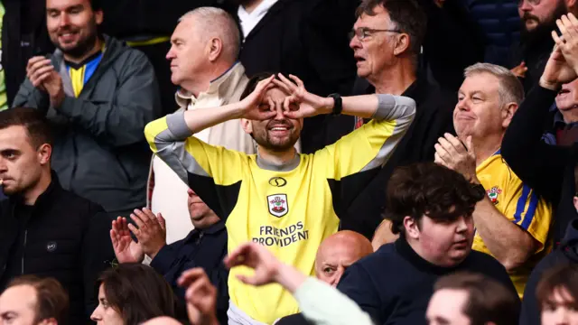 A Southampton fan taunts Boro supporters by holding up his fingers to make a binoculars shape around his eyes