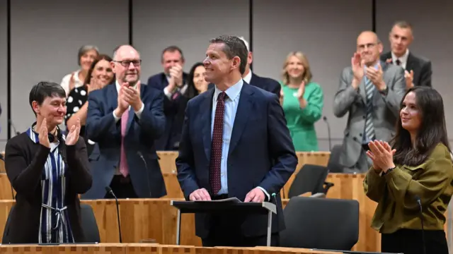 People applauding Rhun ap Iorwerth
