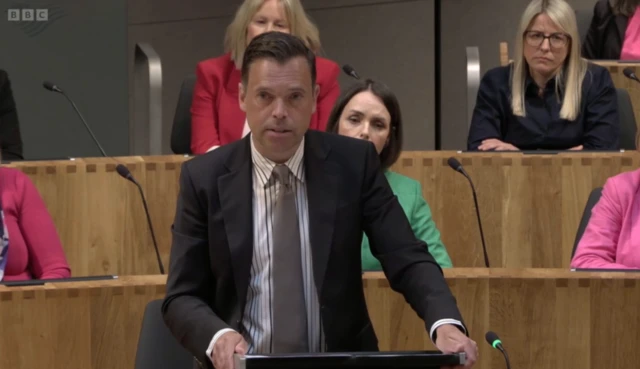 Ken Skates talks at the lectern in the Sendd