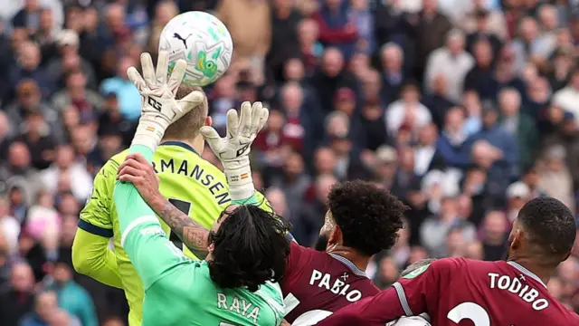 Pablo of West Ham United fouls David Raya of Arsenal