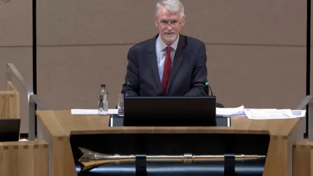 Irranca-Davies in dark suit in Senedd