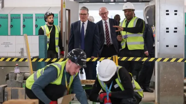 Stamer and Pat McFadden survey the work of construction apprentices
