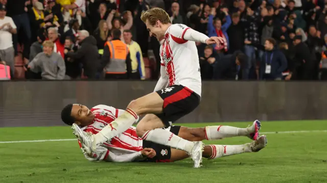 Southampton's Shea Charles is bundled to the ground after his goal
