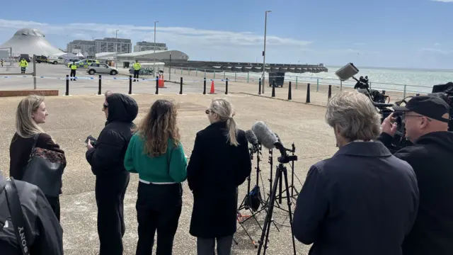 Reporters at seafront