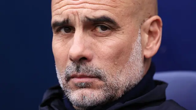 Manchester City manager Pep Guardiola looks on