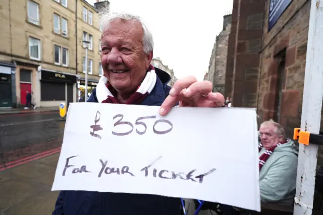 Hearts fan holds up sign reading '£350 for your ticket'