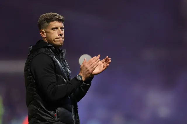Stevenage coach Alex Revell applauding fans