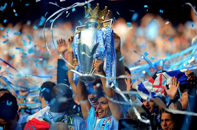 Scorer of the matchwinning goal Sergio Aguero of Manchester City celebrates with the trophy
