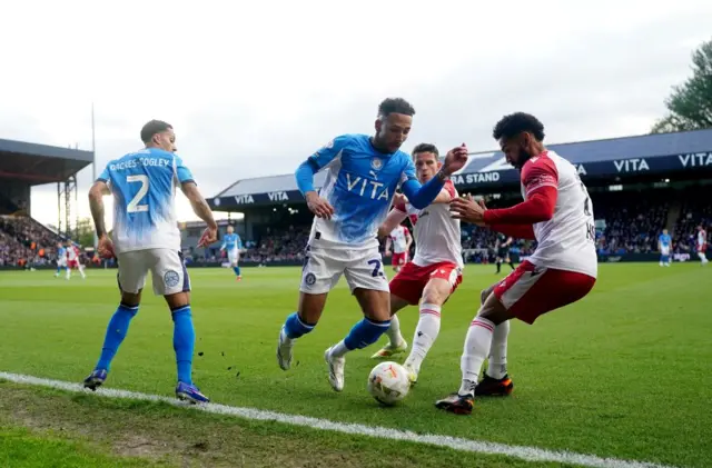 Stockport County's Odin Bailey (centre) and Stevenage's Jordan Roberts and Jordan Houghton battle for the ball