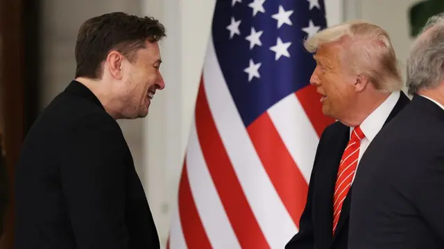 Trump approaches Trump, with both men smiling