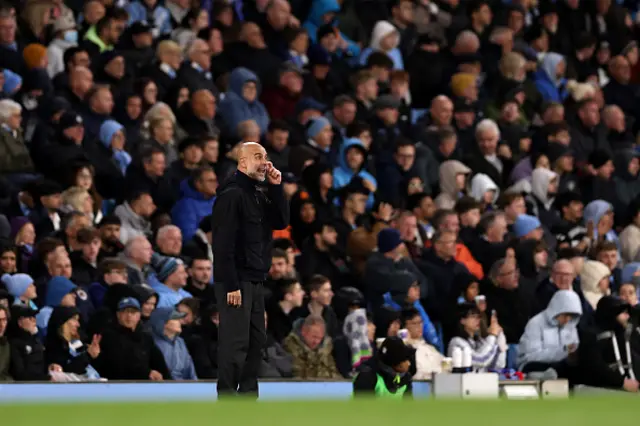 Pep Guardiola, Manager of Manchester City, looks on
