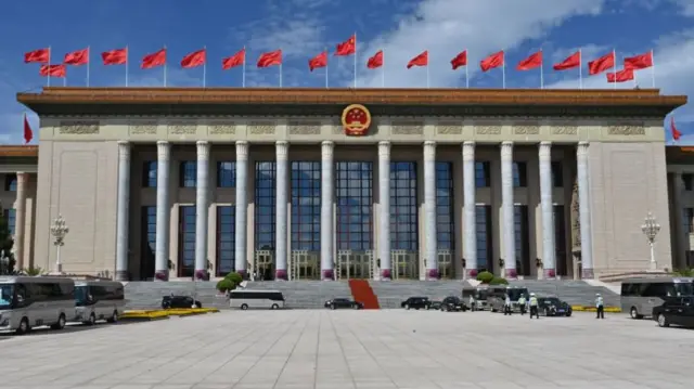 Chinese flags planted across the roof of the Great Hall of the People