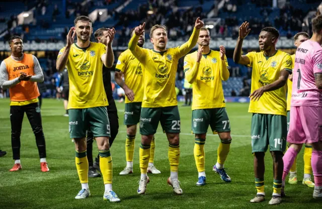 Hibs players celebrate victory at Ibrox