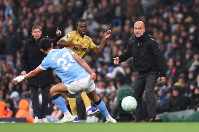 Pep Guardiola looks on