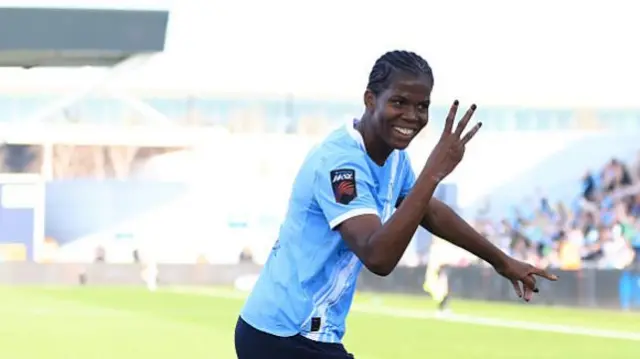 Shaw celebrates her hat-trick v Spurs by holding up three fingers