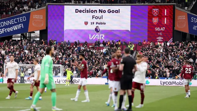The LED board displays the VAR decision that disallowed the goal scored by Callum Wilson of West Ham United, after Pablo of West Ham United fouled David Raya of Arsenal