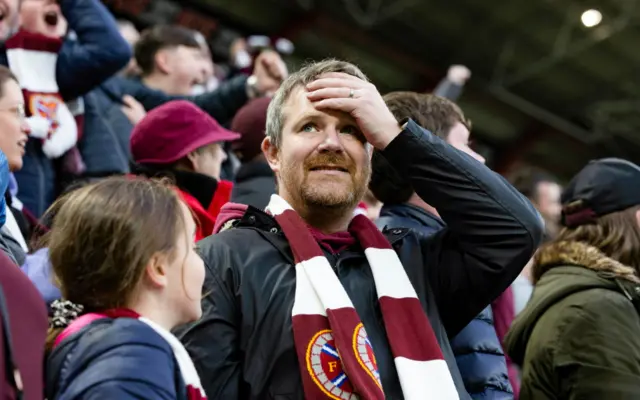 Hearts fan with hand on head