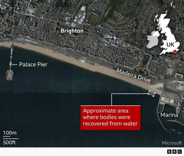 A satellite map of Brighton seafront in the UK showing the coastline, with labels for “Brighton,” “Palace Pier,” “Madeira Drive,” and “Marina.” A red box highlights the approximate area offshore where bodies were recovered from the water, east of the pier near the marina. A small inset map of the UK marks the location in southern England, and a scale bar indicates distance.